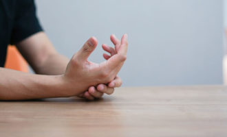 Man with Dupuytren’s Contracture holding his outstretched hand