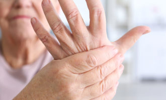 Trapeziectomy. Elderly woman suffering from pain in hand, closeup